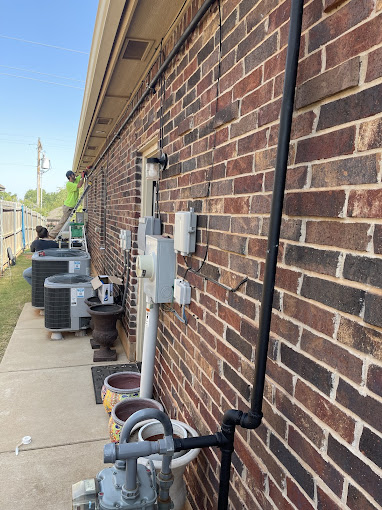 A line of water pumps next to a brick building