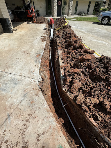 A large pile of dirt in front of a house