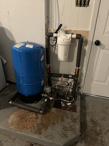 A blue tank sitting next to a white door