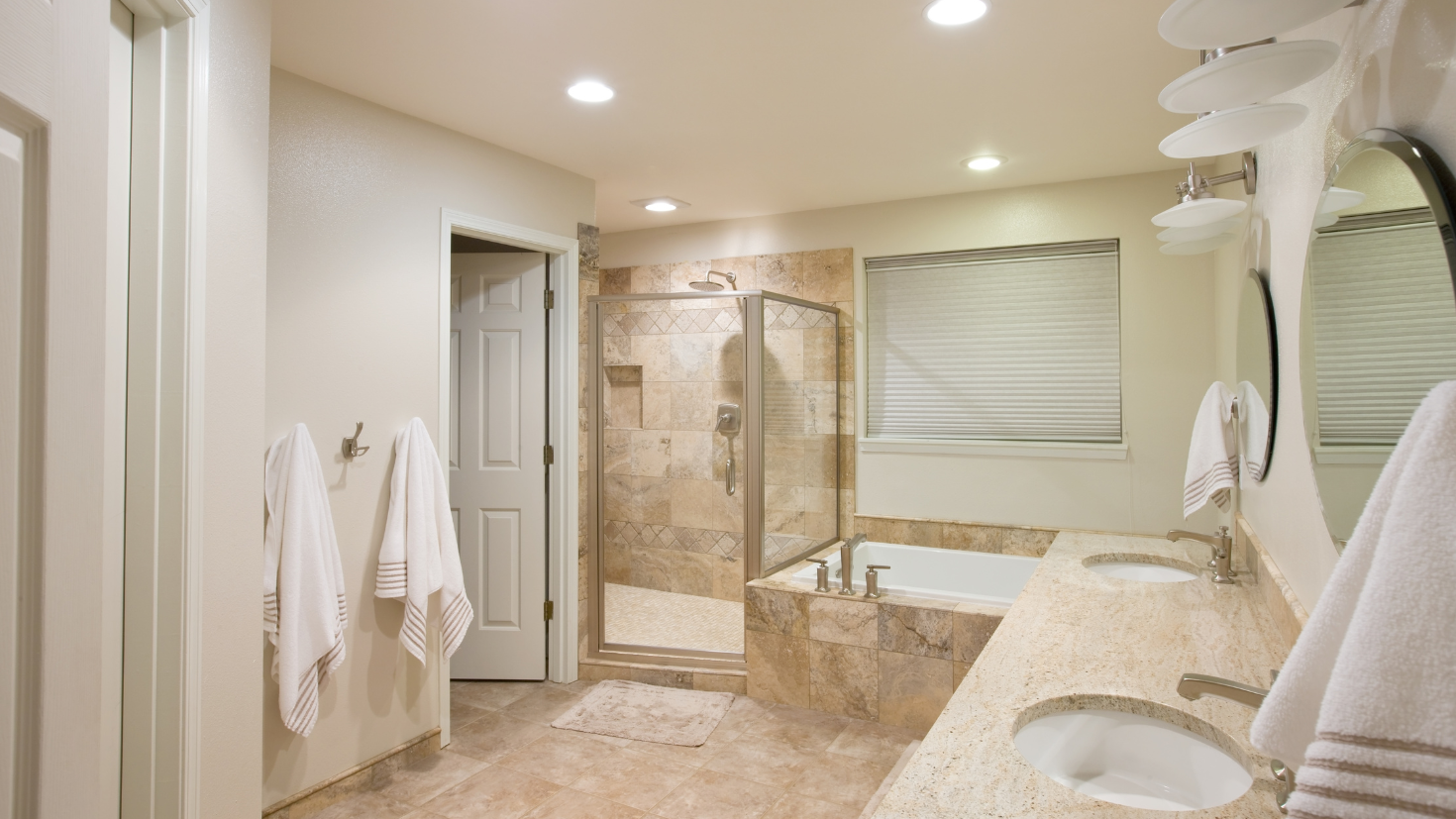 A bathroom with a tub, sink, and shower