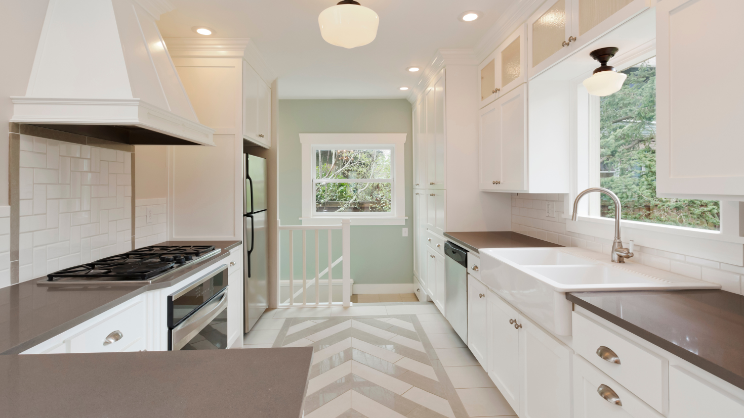 A kitchen with a stove top oven sitting next to a sink