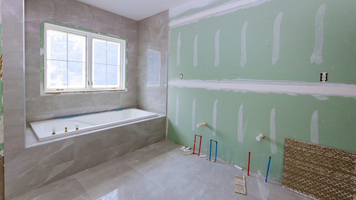 A bathroom with a tub and a window in it