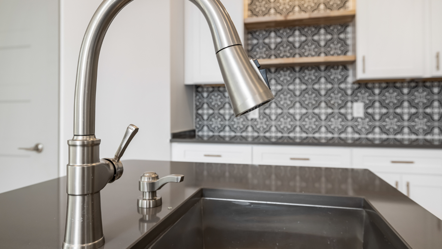 A kitchen sink with a faucet over it